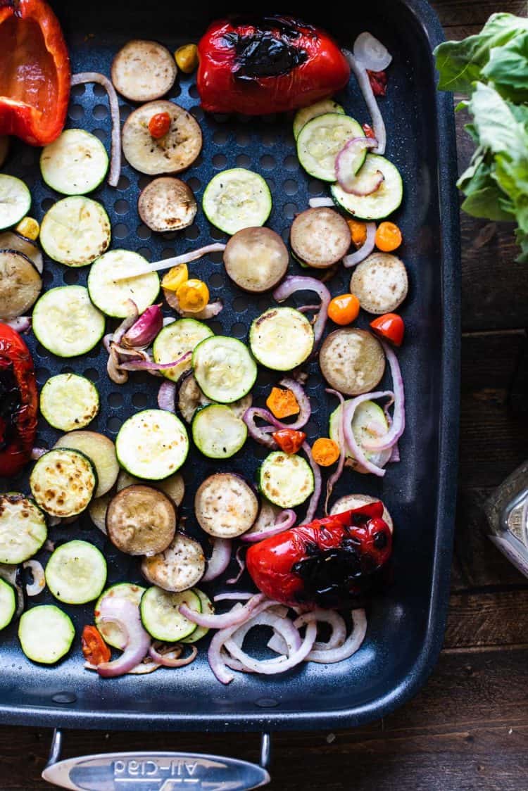Grilled zucchini, eggplant, onions, bell pepper on grill pan for Grilled Vegetable Pizza.