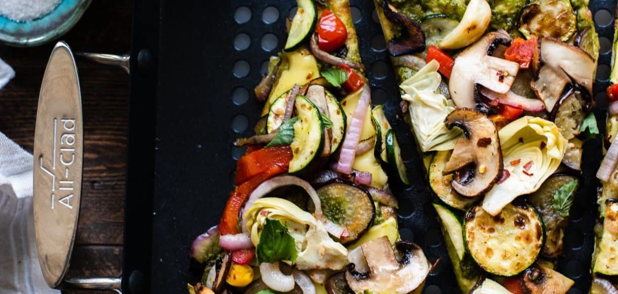 Slices of grilled vegetable pizza on a grill pan.