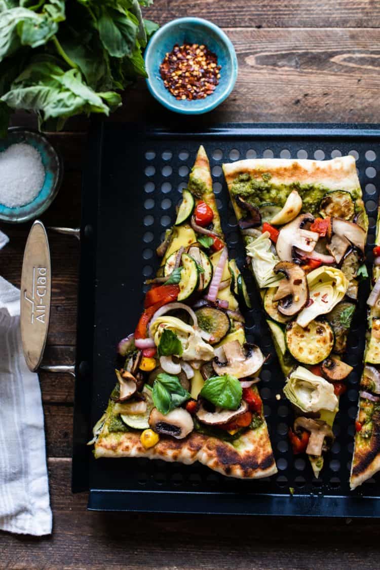 Slices of grilled vegetable pizza on a grill pan.