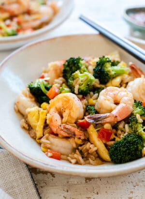 Spicy Shrimp Fried Rice in a cream bowl with chopsticks.