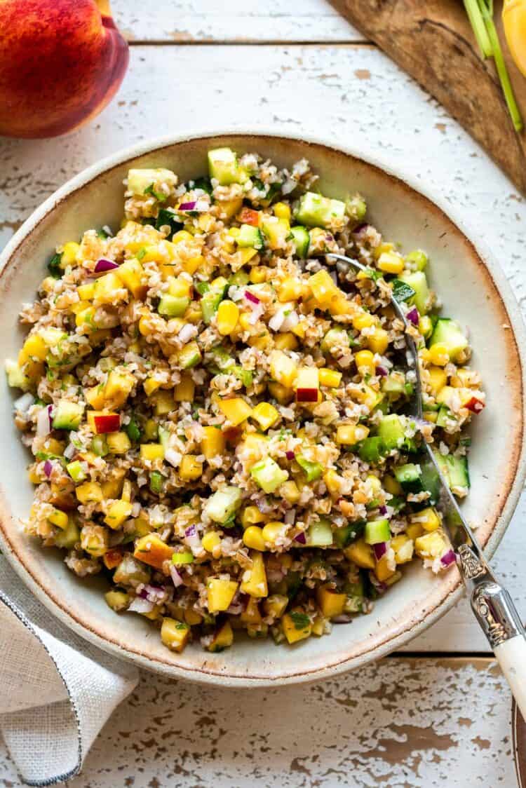 Summer Corn and Nectarine Tabbouleh in a cream colored serving dish.