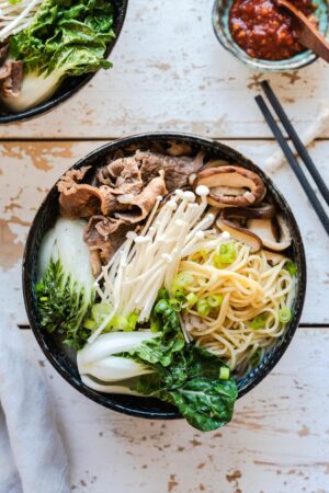 Beef noodle soup in a bowl: mushroom and short rib noodle soup with bok choy.