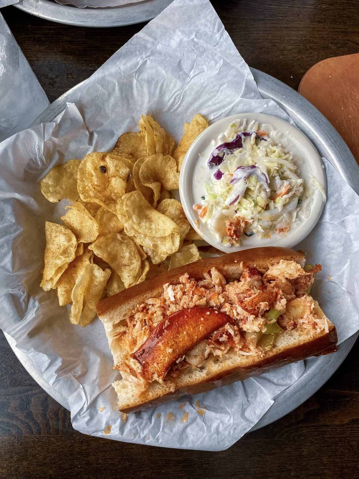 lobster roll with chips and coleslaw