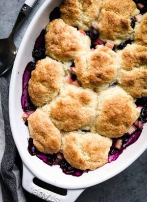 Blueberry Rhubarb Cobbler in a white oval baking dish.