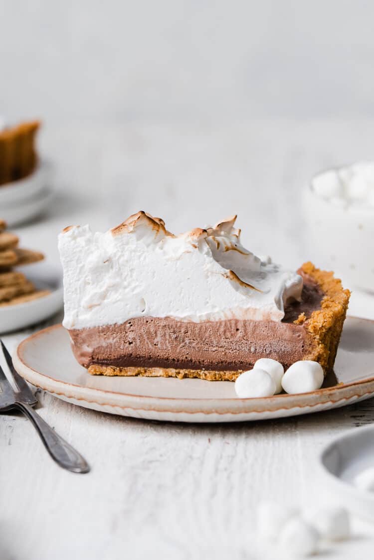 A slice of S’mores Ice Cream Pie on a cream plate.