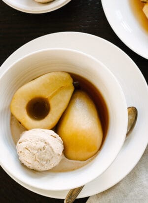 Tea Poached Pears with Earl Grey Ice Cream in white bowls.