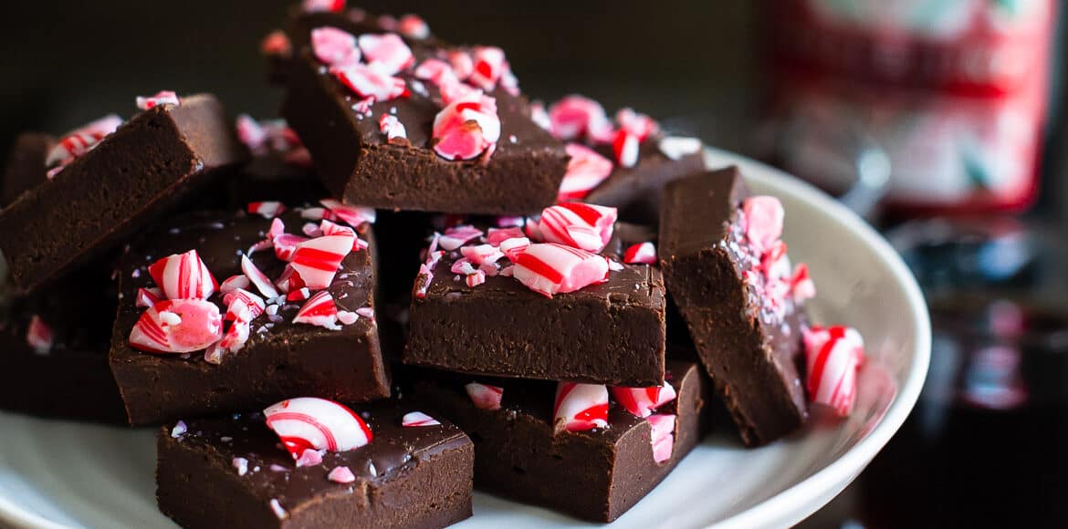 A white cake stand filled with squares of Dark Chocolate Kahlúa Peppermint Mocha Fudge.