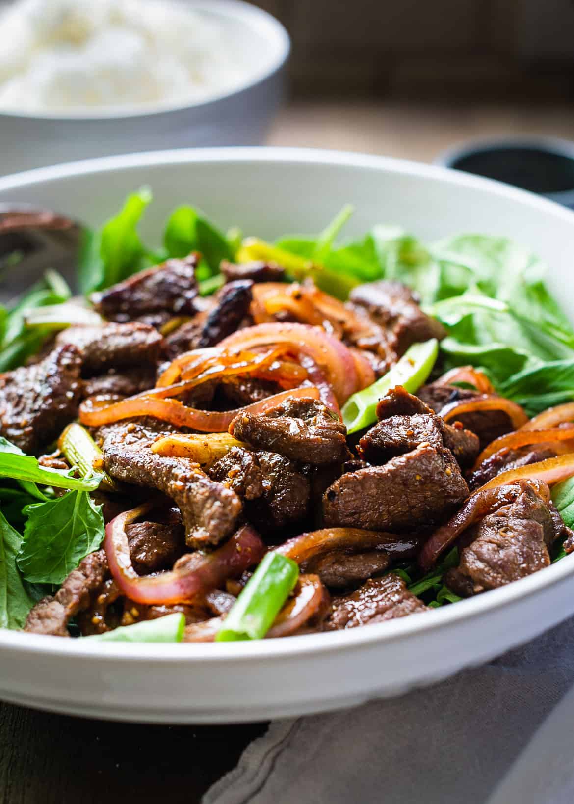 Shaking Beef Stir Fry served over greens.