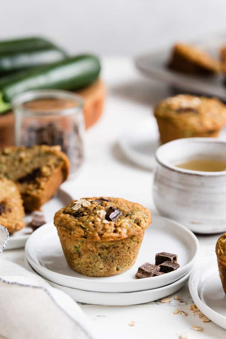 Zucchini Oat Chocolate Chunk Muffins on small white plates.