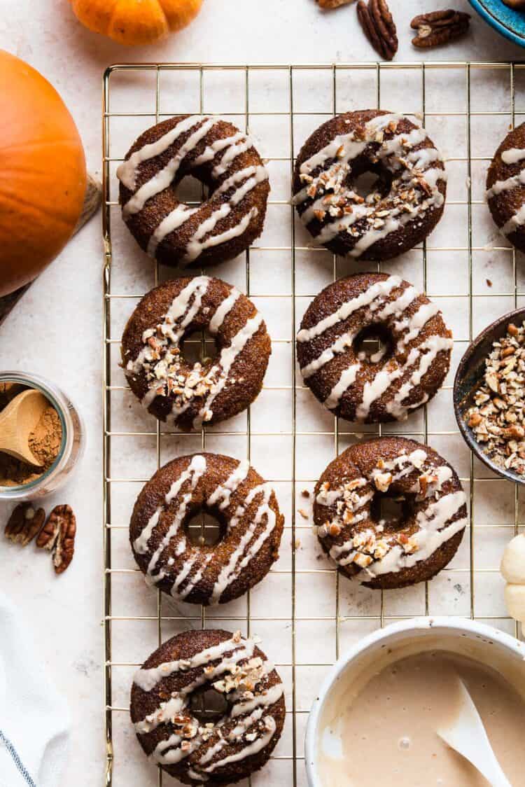 Baked Pumpkin Donuts with Almond Flour and Spiced Maple Glaze on a cooling rack.