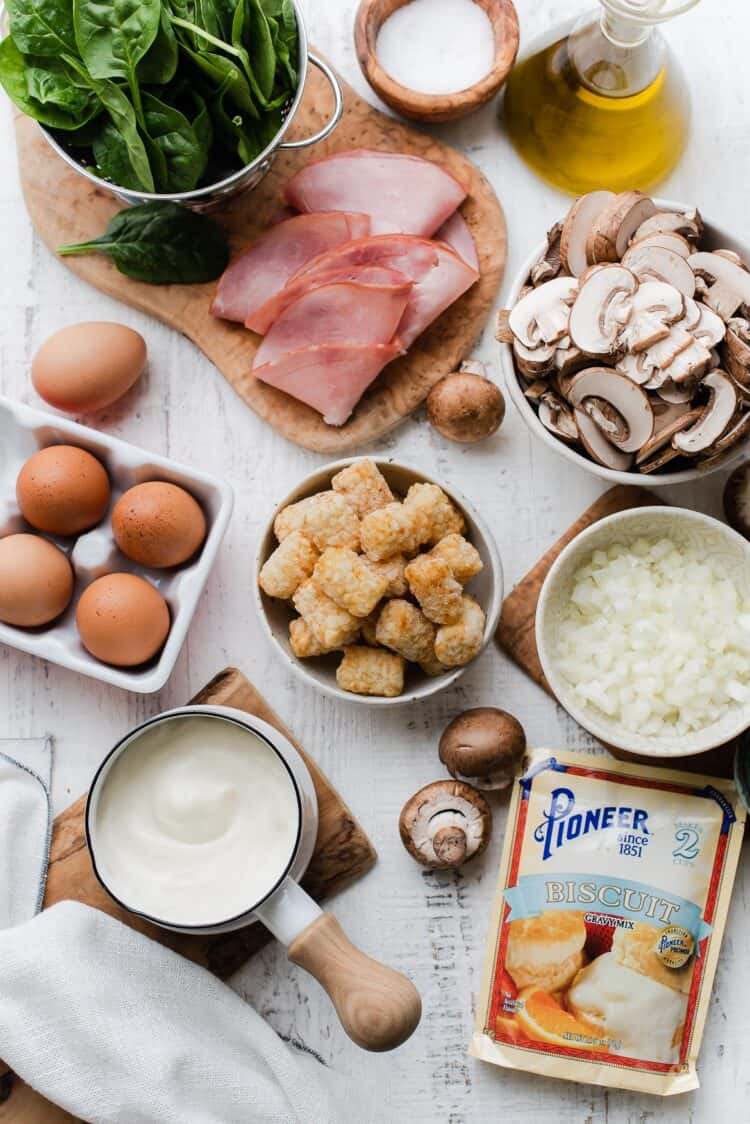 Ingredients for Tater Tot Breakfast Casserole on a white wooden table with Pioneer Biscuit Gravy.