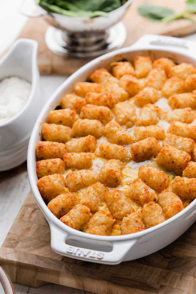 Tater Tot Breakfast Casserole in a white oval baking dish.