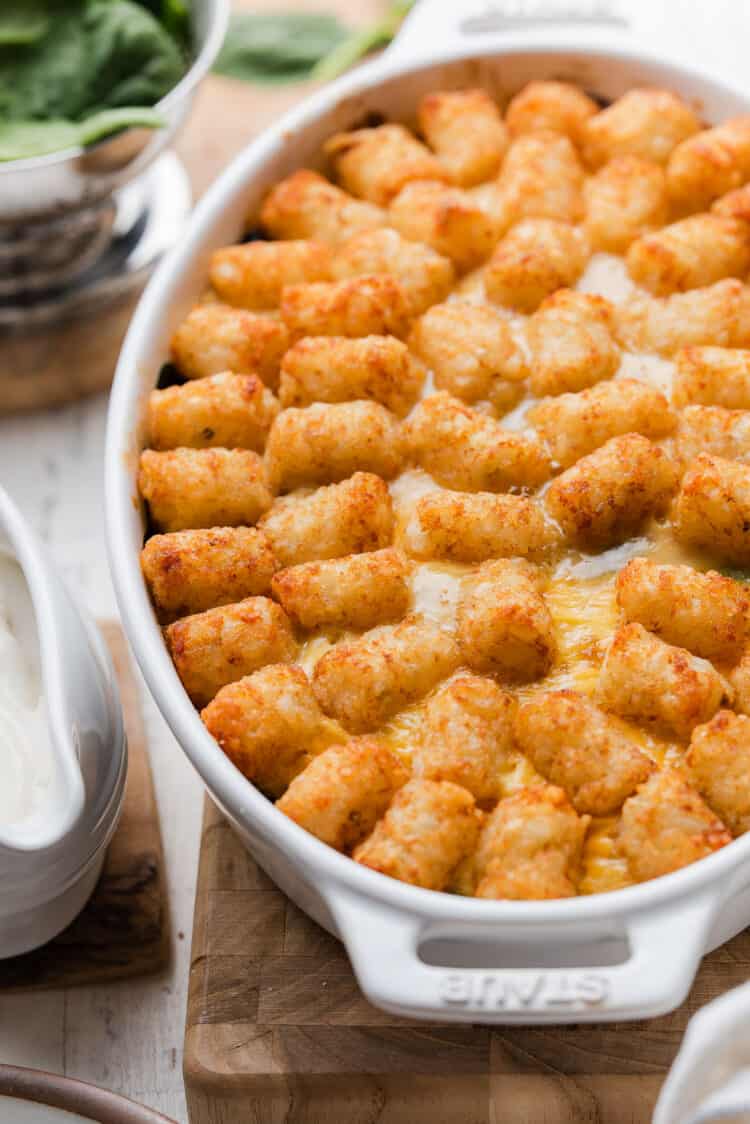 Tater Tot Breakfast Casserole in a white oval baking dish.