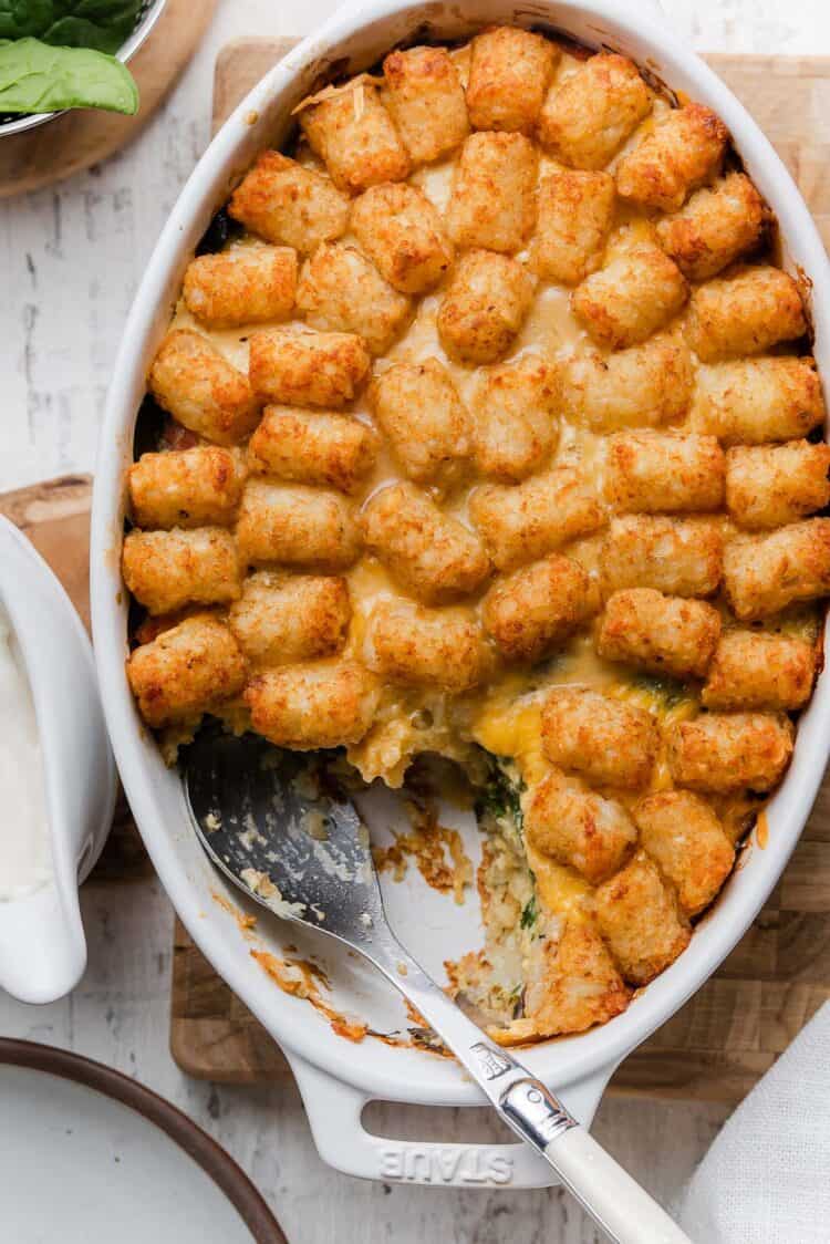 Serving a scoop of Tater Tot Breakfast Casserole