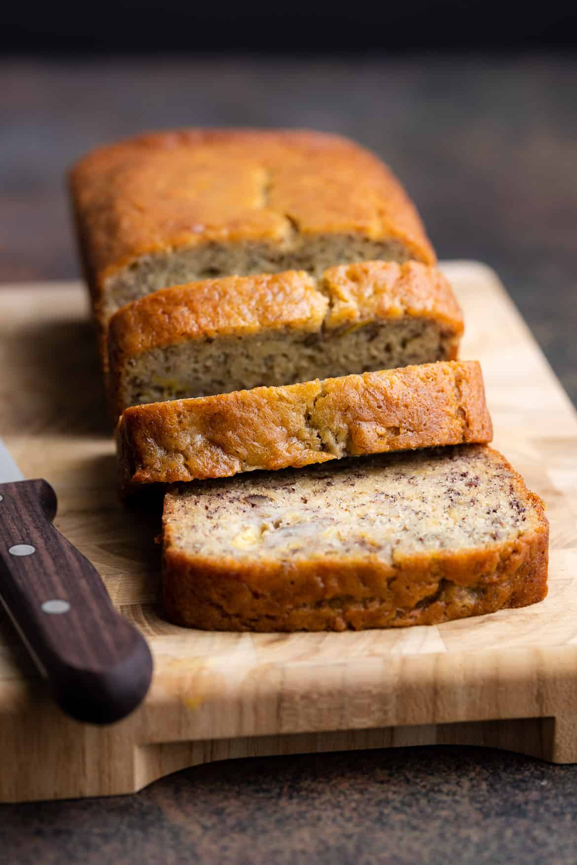 Buttermilk Banana Bread sliced on a cutting board.