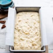 Buttermilk Banana Bread batter in a parchment lined loaf pan.
