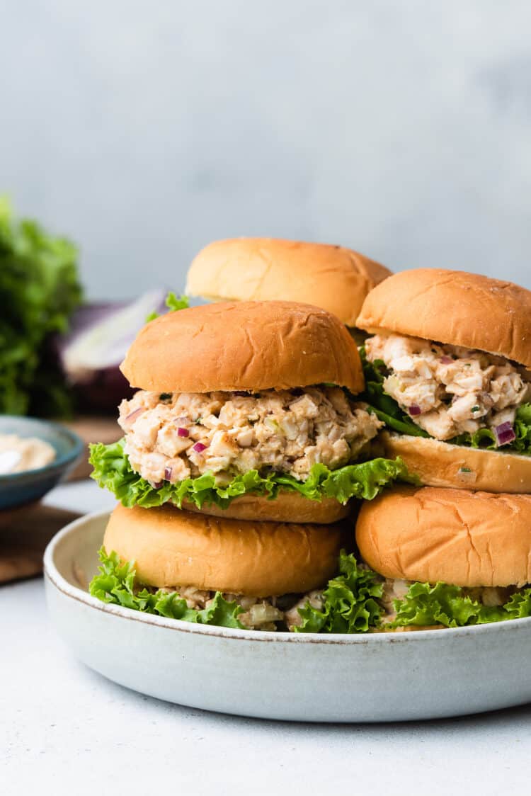 Stack of hummus chicken salad sliders in a grey dish.