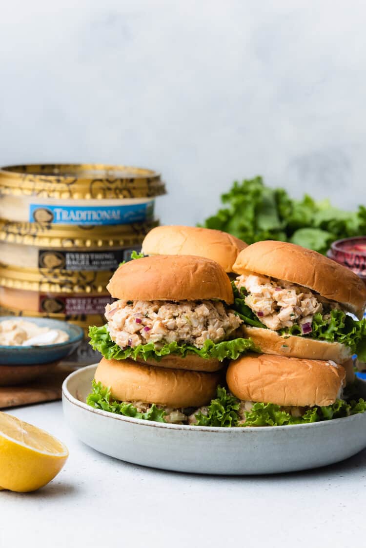 Stack of Hummus Chicken Salad Sliders with Boar's Head Hummus in the background.