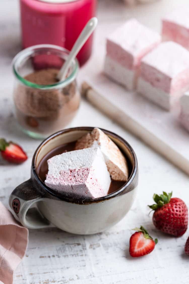 Homemade Strawberry Vanilla Marshmallows in a cup of hot chocolate.
