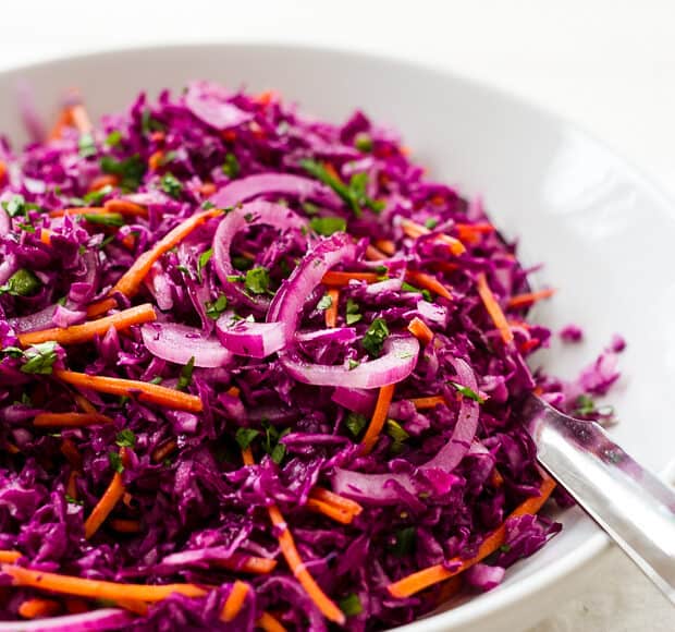 Shredded cabbage slaw in a white bowl.
