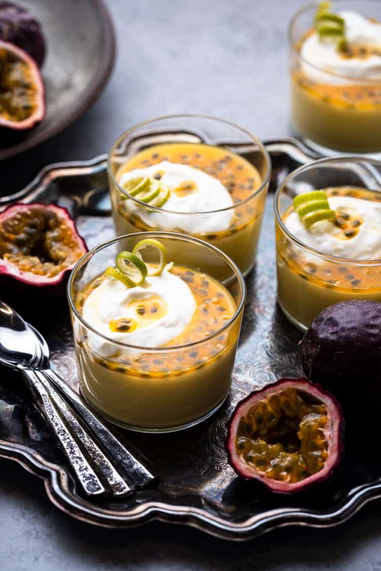 Passion Fruit Posset on a tray with fresh passion fruit.