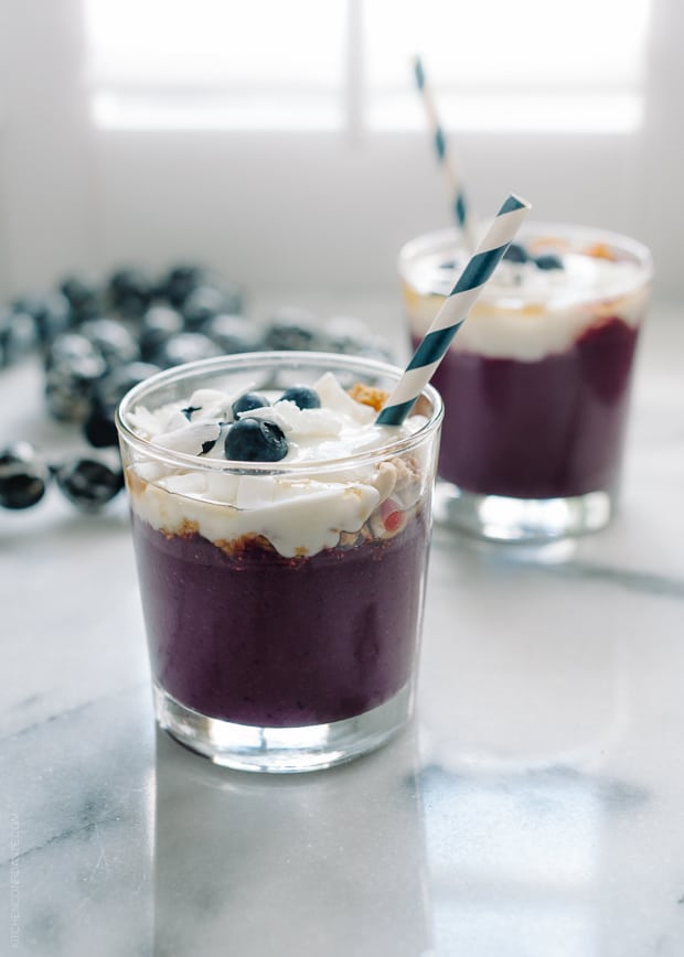 Açaí Smoothie served in a glass topped with yogurt and granola.