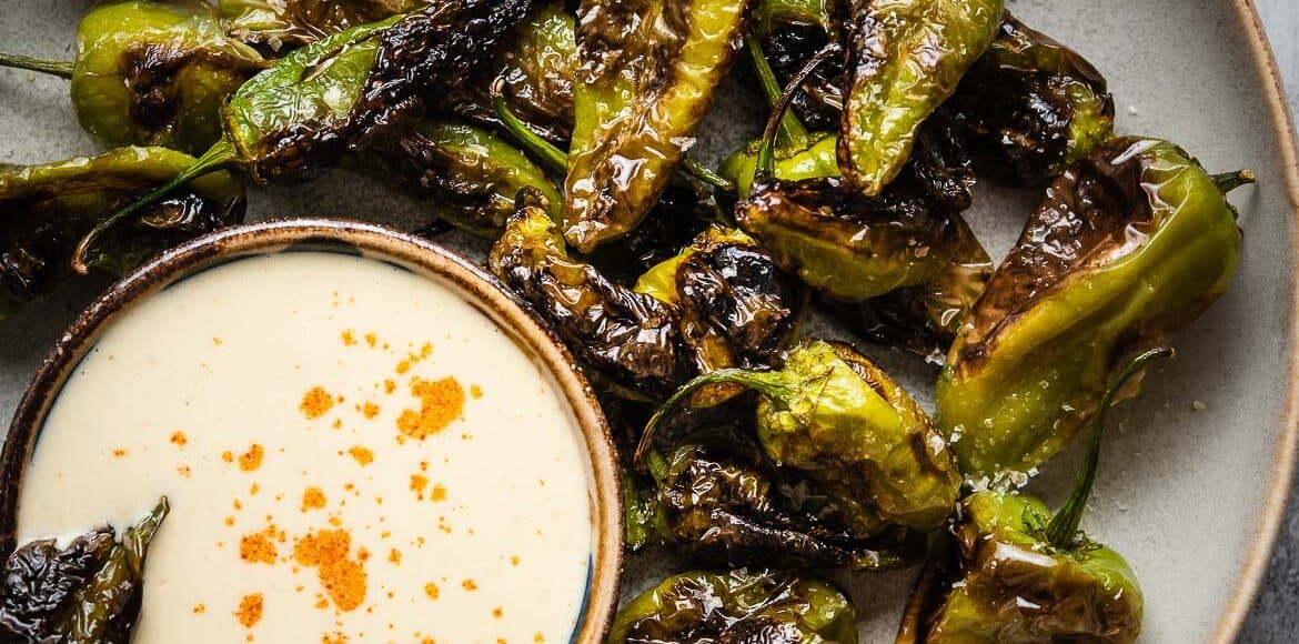 Blistered Padrón Peppers served with a bowl of Buttermilk Aioli.