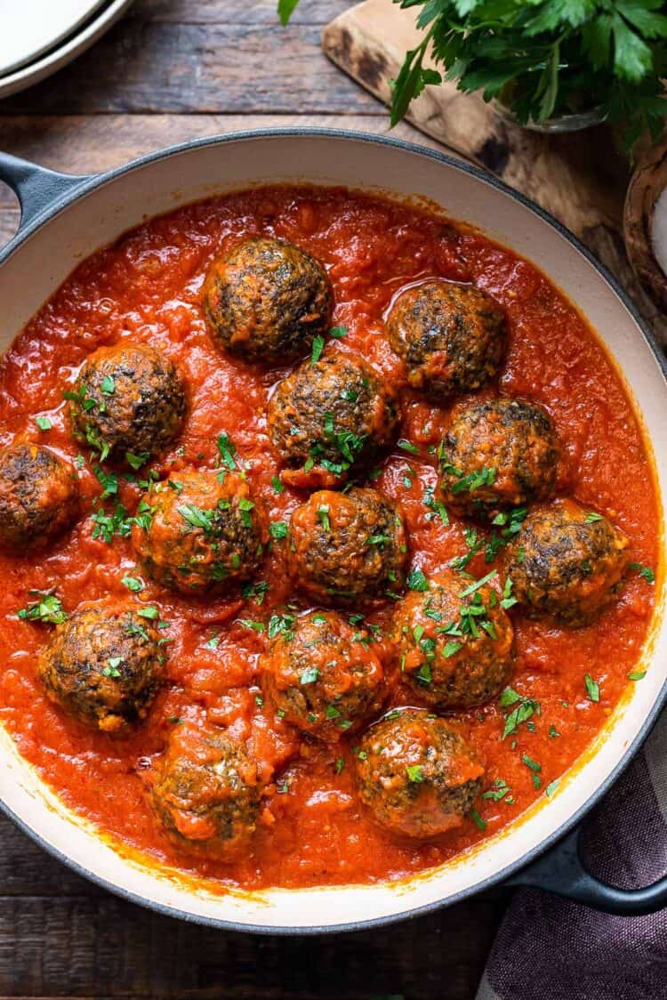 Mushroom meatballs in marinara sauce in a pan.