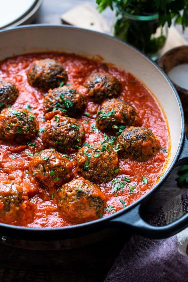 Mushroom meatballs simmering in marinara sauce