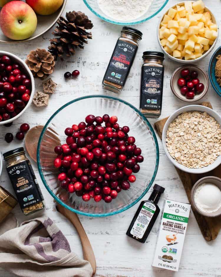 Ingredients for Cranberry Apple Crisp on a white table.