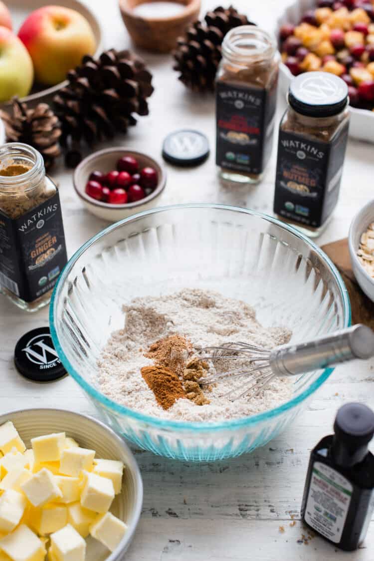 Dry ingredients for Cranberry Apple Crisp in a glass bowl.