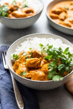 Butternut Squash Butter Chicken with white rice and cilantro in a bowl.