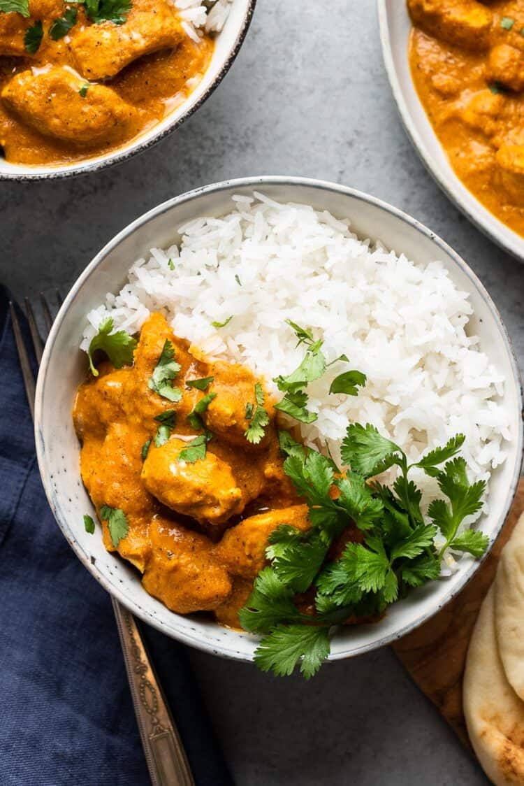 Butternut Squash Butter Chicken with white rice and cilantro in a bowl.