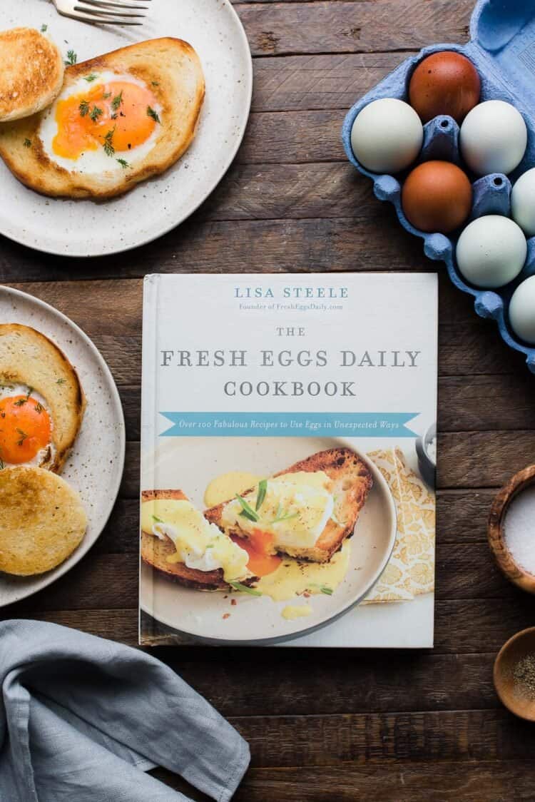 The Fresh Eggs Daily Cookbook on a wooden table