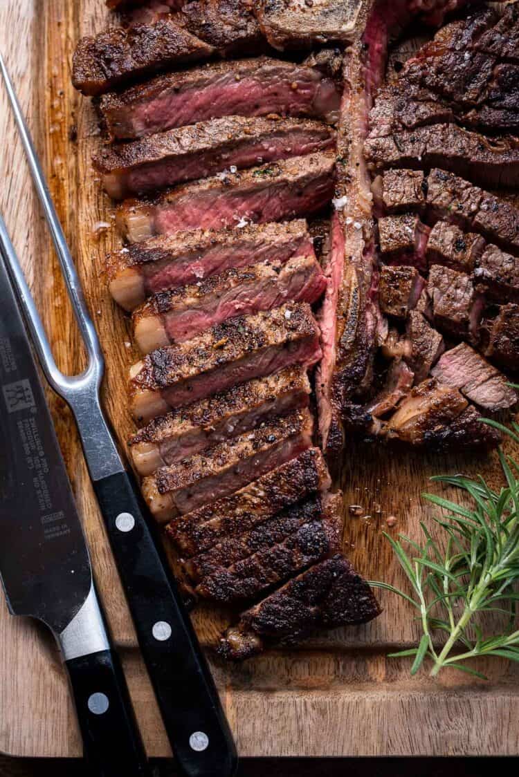 Angus Beef Steak sliced on a wooden cutting board