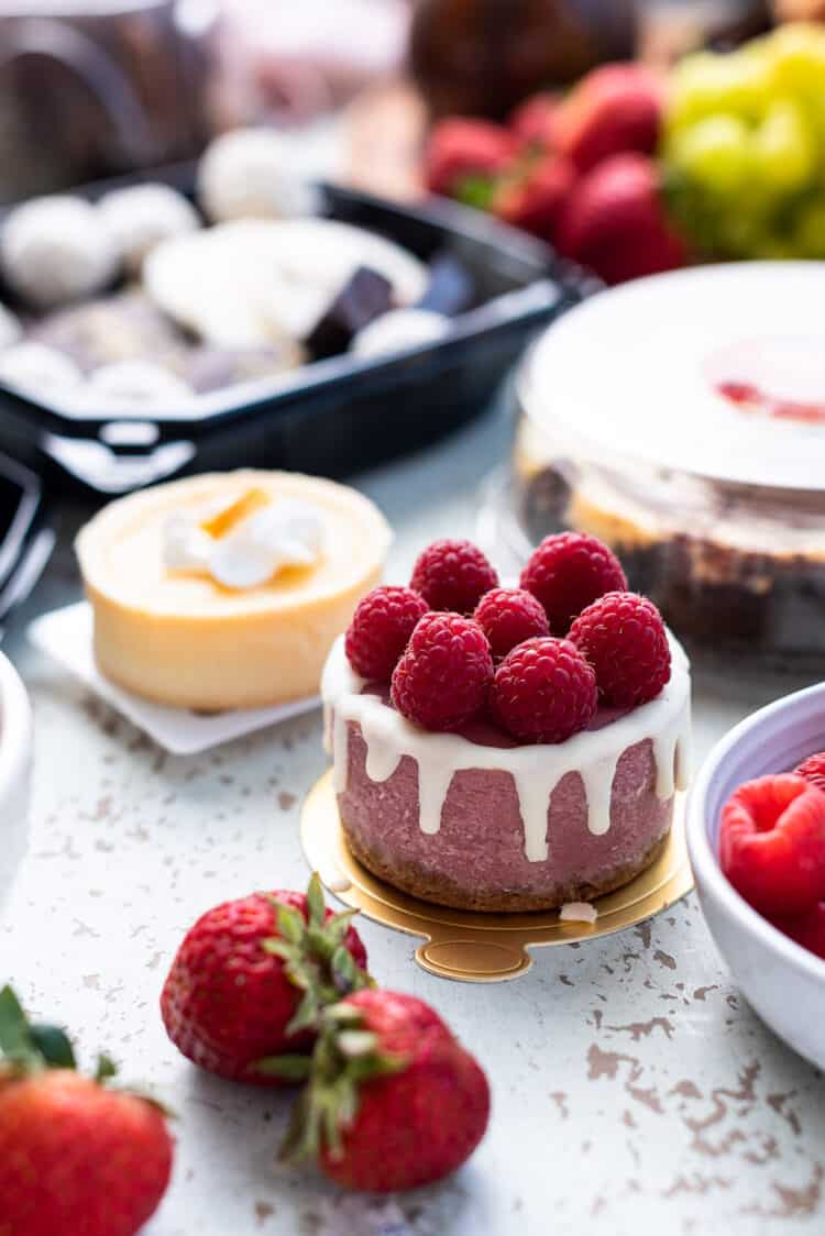 Raspberry cheesecake and treats for a simple dessert charcuterie board