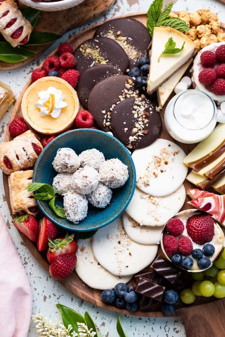 Simple Dessert Charcuterie Board with fruit, cookies, cake, cheesecake, candied apples, and more!