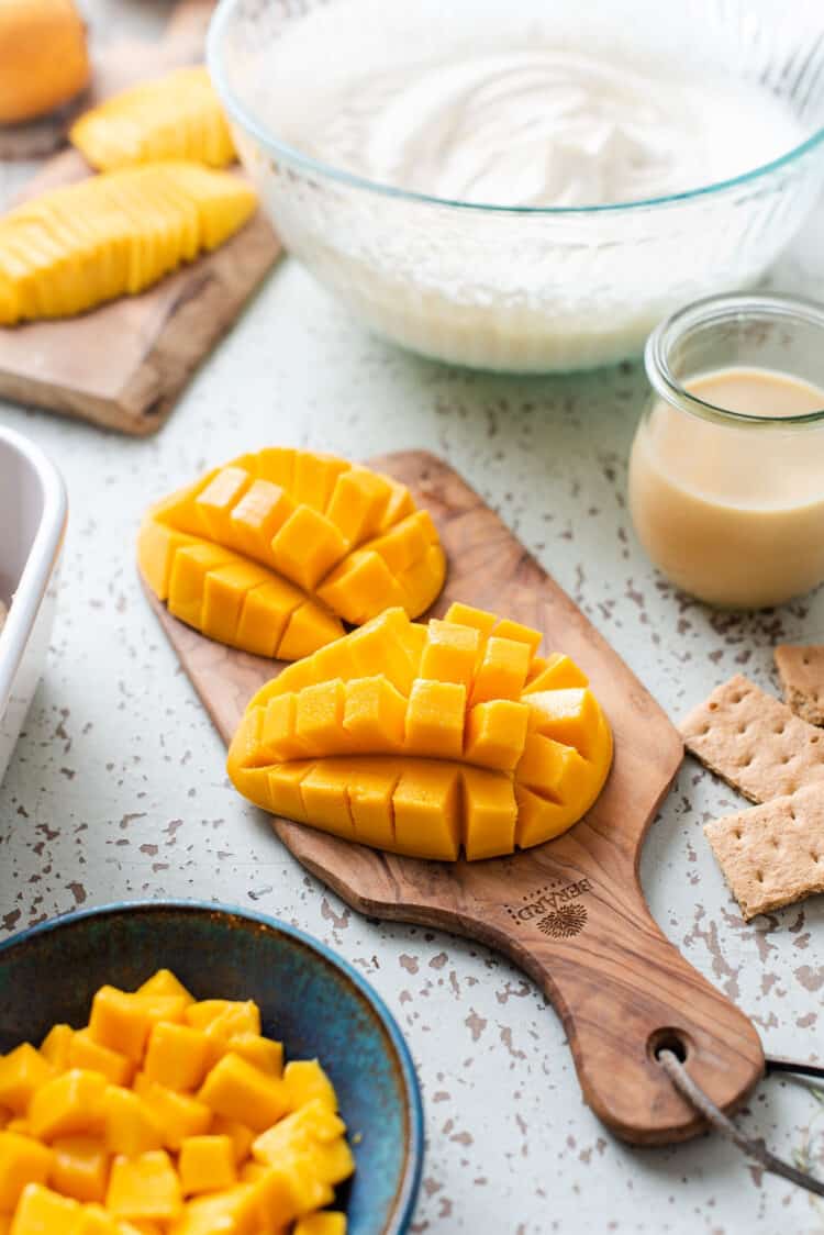 Mangoes for Mango Float on a wooden board.