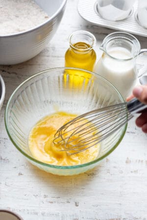 Whipping eggs in a ribbed glass bowl.
