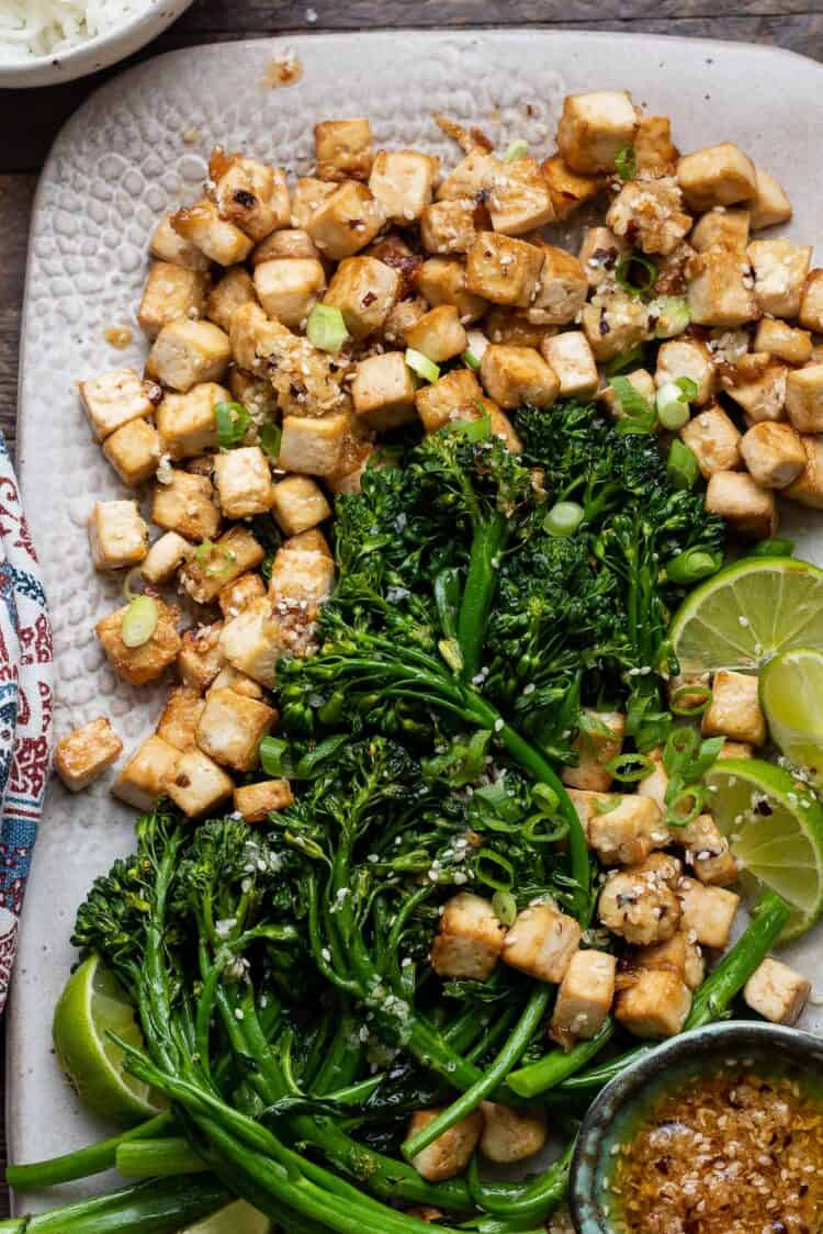 Firecracker Tofu With Broccolini and Chili Garlic Oil on a white plate.