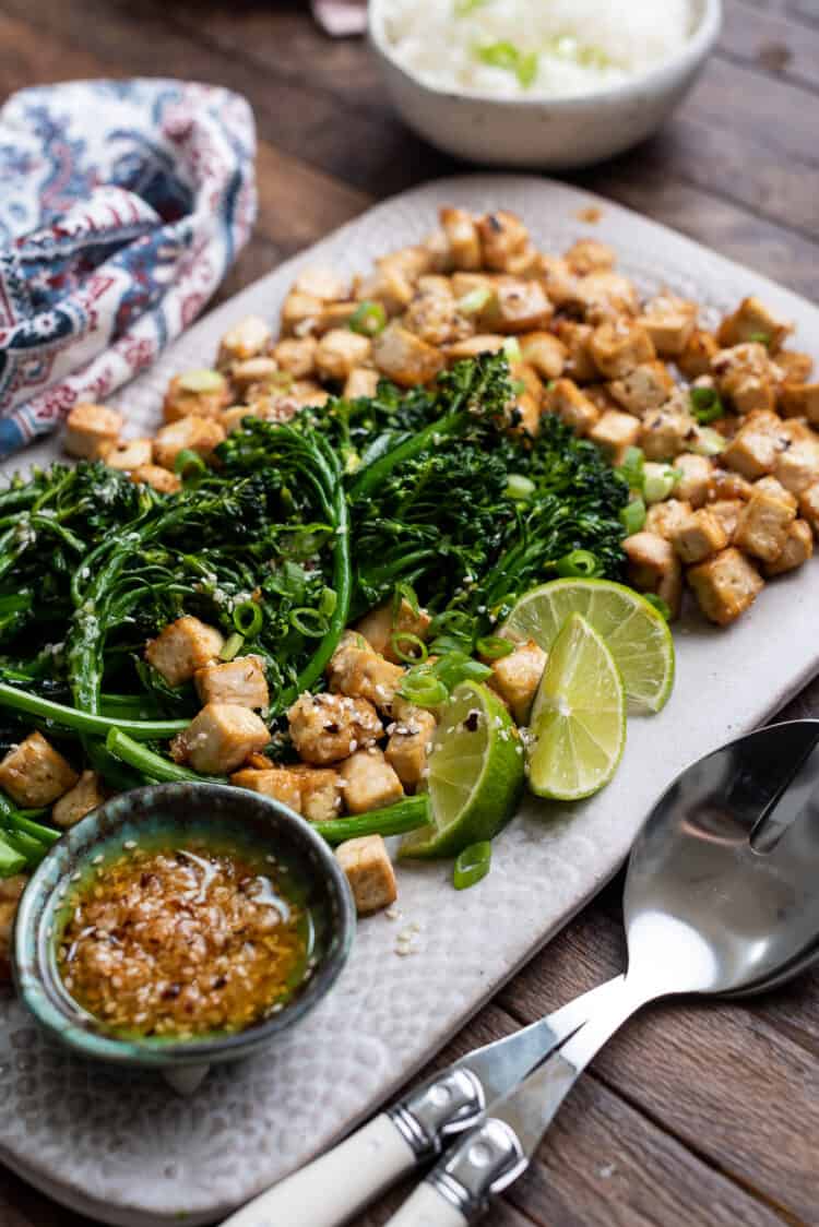 Firecracker Tofu With Broccolini and Chili Garlic Oil on a serving platter.