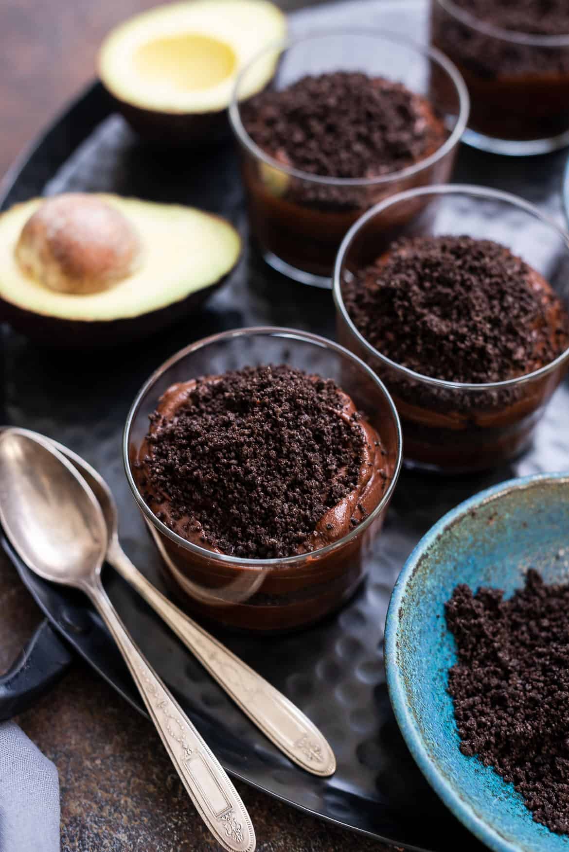 Making Halloween Dirt Cups with Avocado Chocolate Pudding in glass cups.