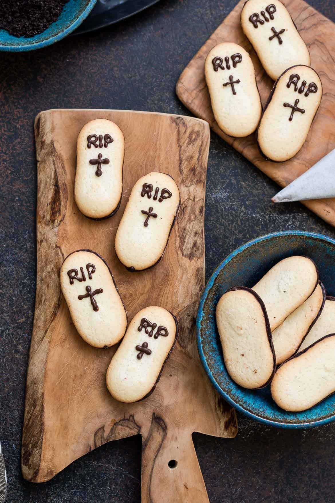 Decorating tombstone cookies made from Milano cookies.