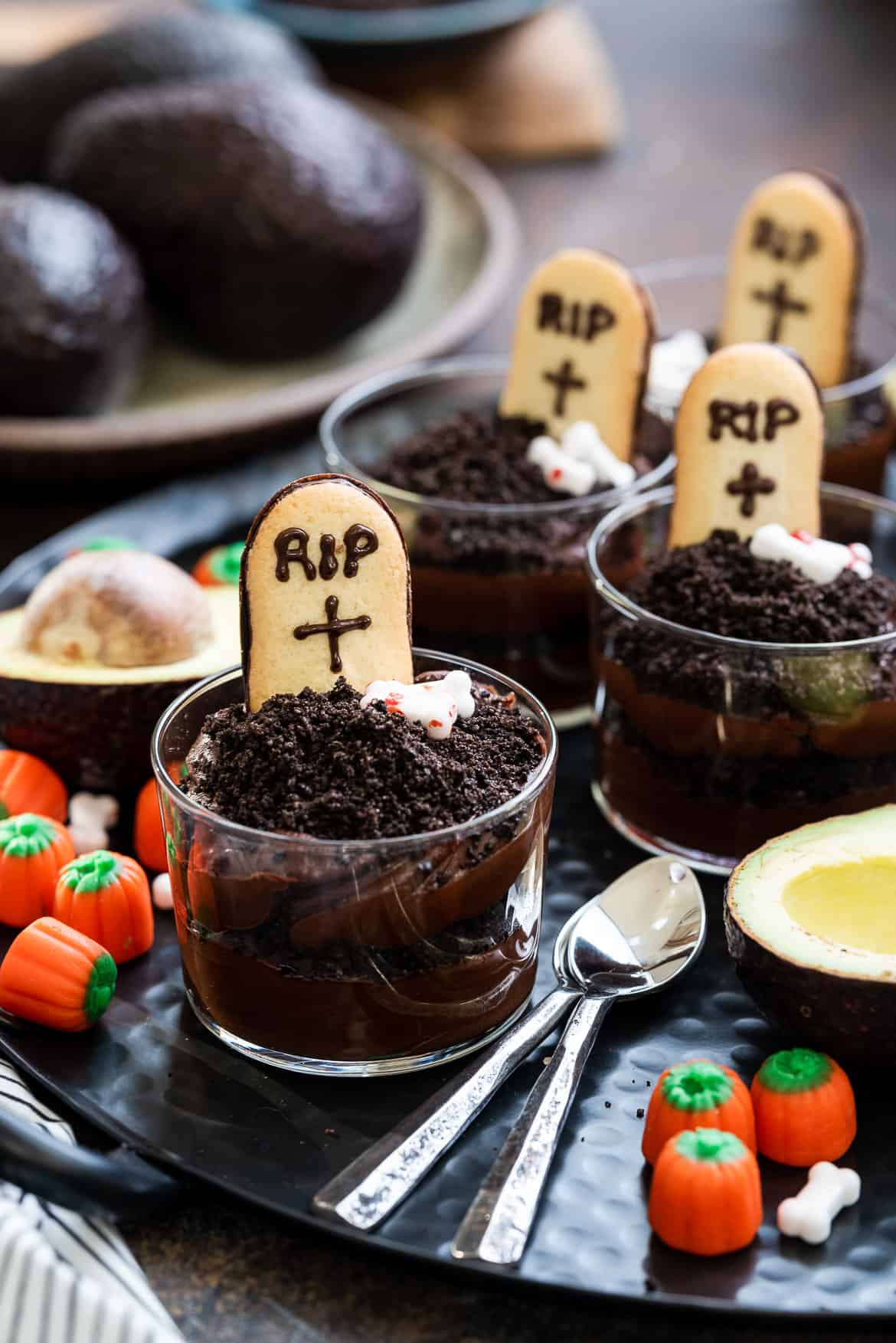 Halloween Dirt Cups with Avocado Chocolate Pudding decorated with tombstone cookies.