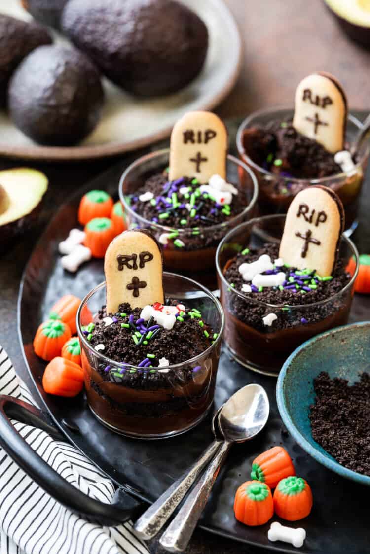 Halloween Dirt Cups with Avocado Chocolate Pudding decorated with tombstone cookies.