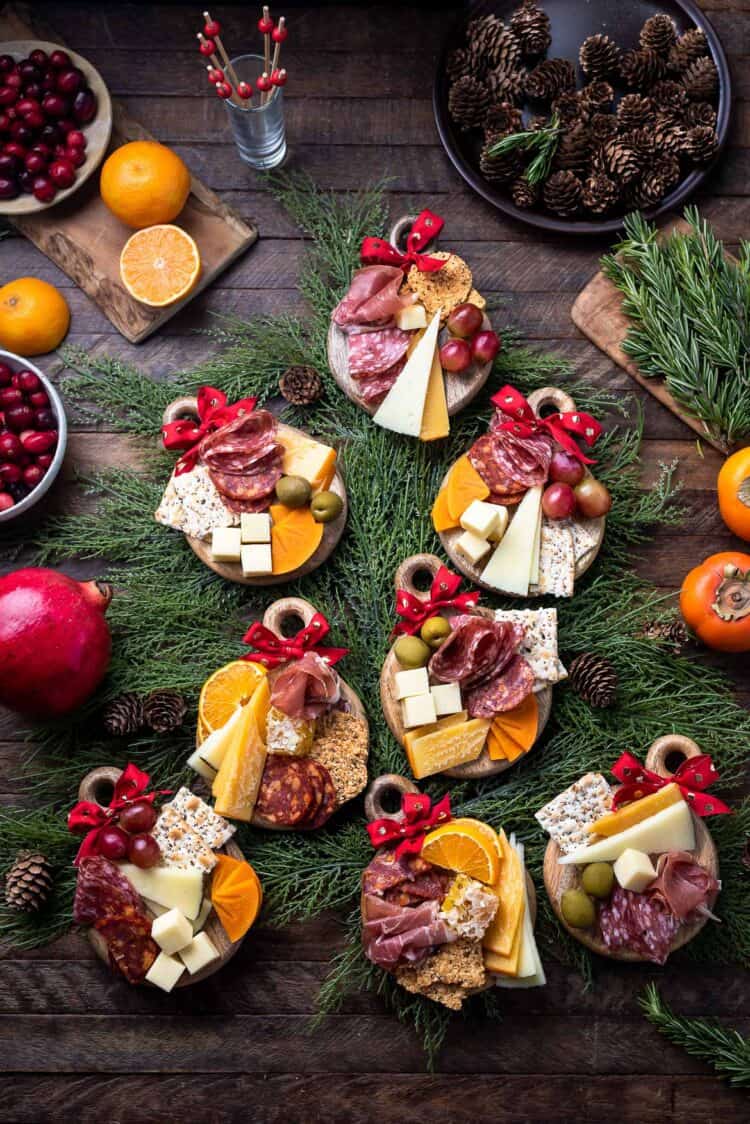 Individual Christmas Charcuterie Boards on mini cheese boards that look like Christmas ornaments.