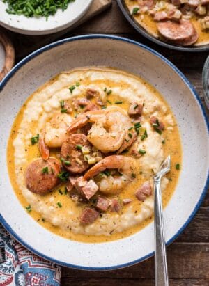 Shrimp and Smoked Sausage with Aged Cheddar Grits in a bowl.