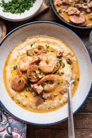 Shrimp and Smoked Sausage with Aged Cheddar Grits in a bowl.