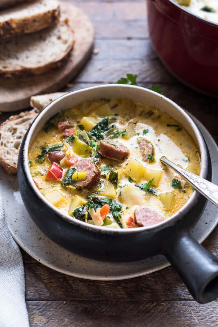 Potato and sausage soup with Swiss chard in a bowl.