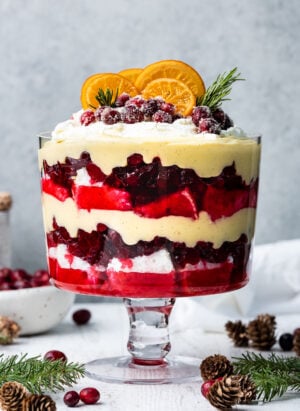 Cranberry Trifle in a trifle bowl, topped with sugared cranberries and candied oranges.